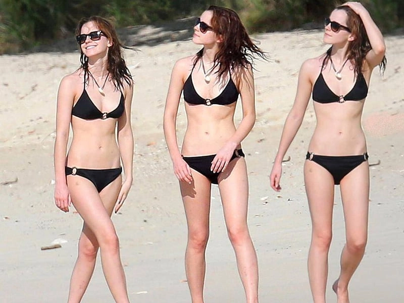 Emma Watson shows off her incredible figure in a black wetsuit.